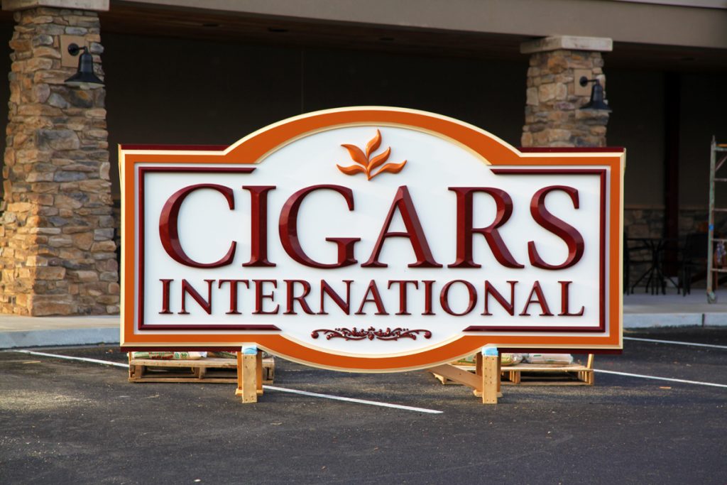 Cigars International is a HDU dimensional sign with applied cut out prizm letters, graphic & boarders