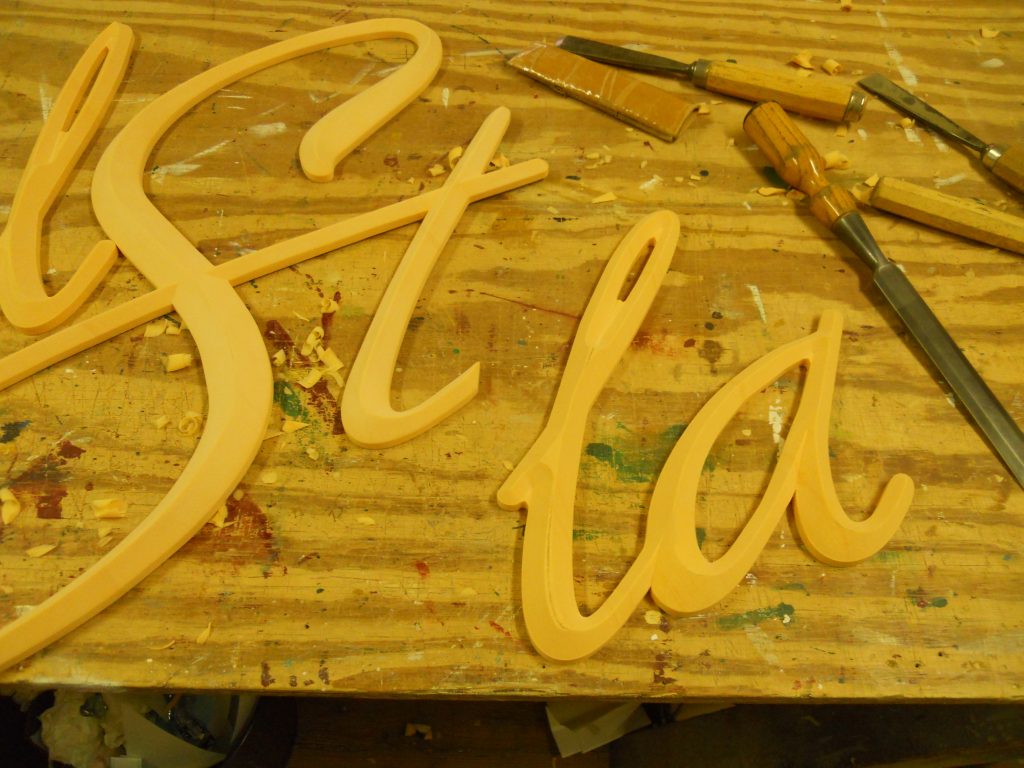 Cut out HDU letters that were applied to carved sign